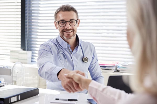 Doctor Shaking Hands with Finance Approval