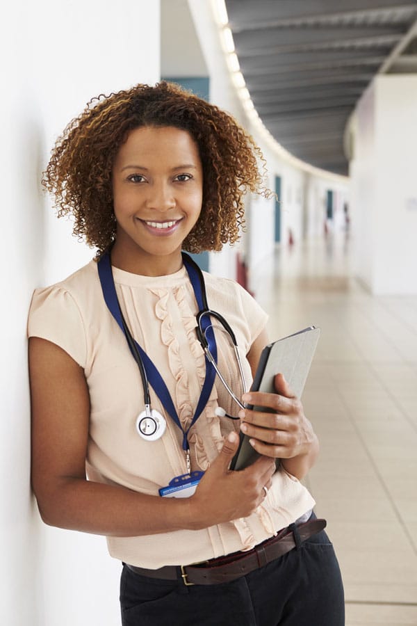 Young female doctor junior standing in hallway jho sho