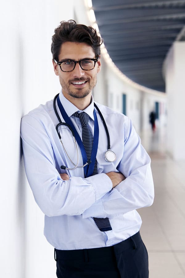 Male Doctor Standing in hallway - registrar health officer